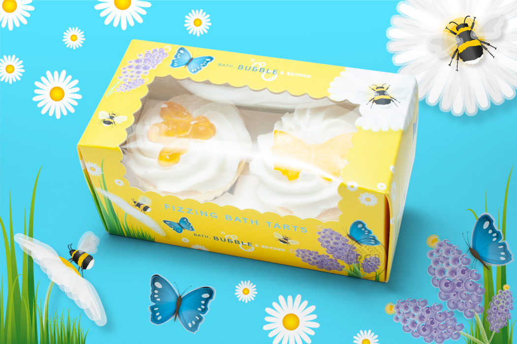 Pretty, yellow-coloured box containing two fizzing bath tarts with window, showing illustrations of bees, flowers and butterflies – designed by Paul Cartwright Branding.